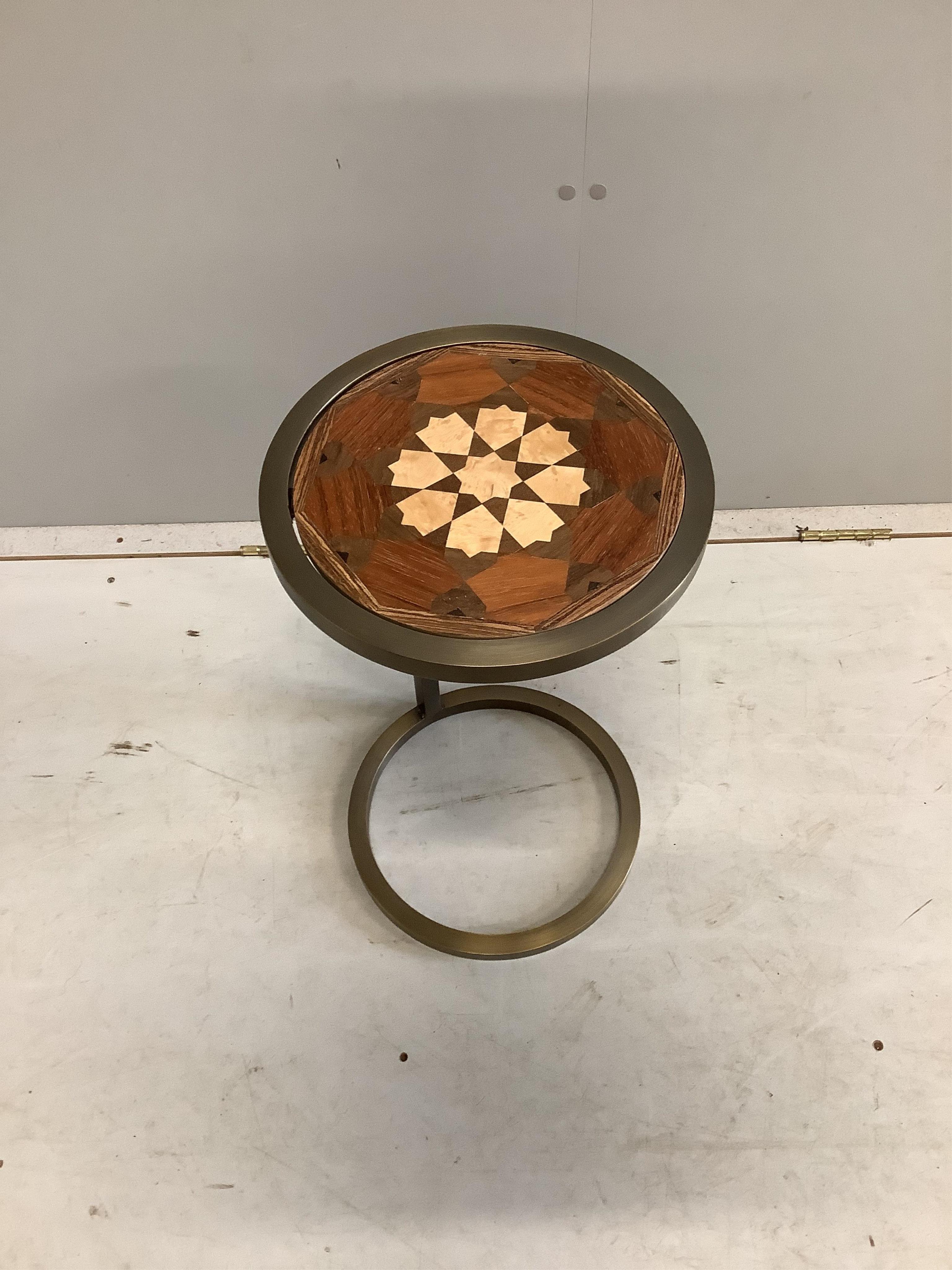 A Contemporary circular occasional table with reversible parquetry inlaid top, diameter 30cm, height 53cm. Condition - good